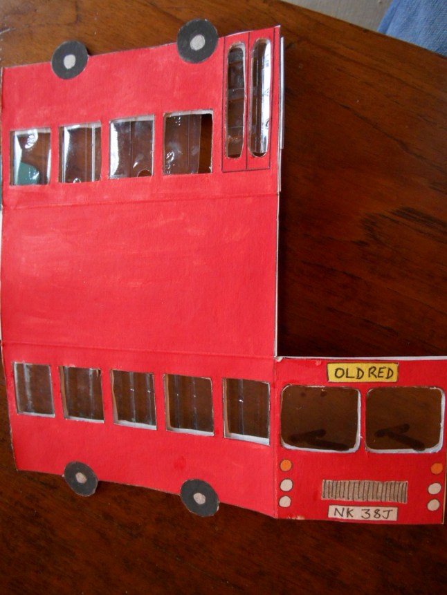 Then I cut out some clear plastic from an old fruit punnet and stuck it on the inside. Now my windows have 'glass'!