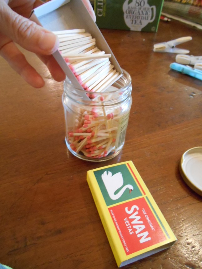 I found some boxes of matches in the drawer and decided my husband wouldn't mind if I used the boxes - I left him the bit with the striking strip!