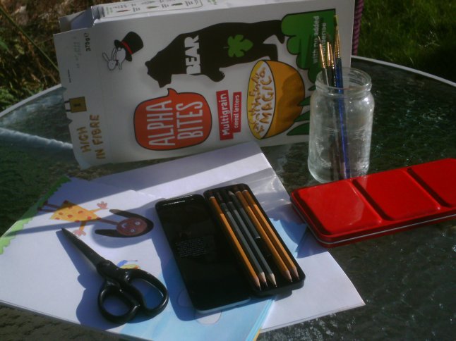 All you need is some cardboard (maybe from  an old cereal box); some paper (I used the back of some sketchbook pages I'd already used); a pencil; some paint or crayons and some scissors (careful with those!)