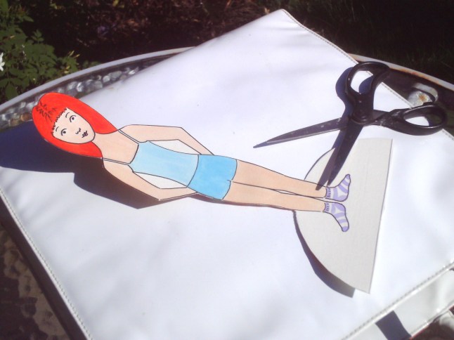 cut her our (remembering to cut around the semi-circle at the base, not around her feet)