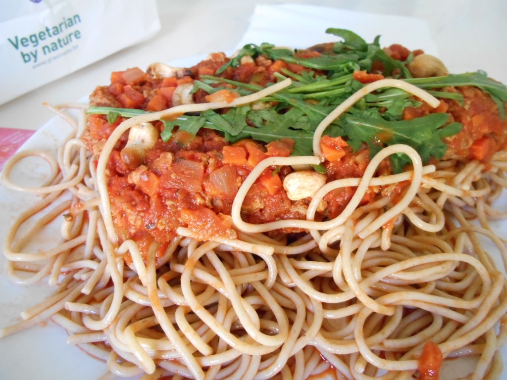 Take away food in paper bag from Greenway vegetarian restaurant.  Vegan Spaghetti bolognese.